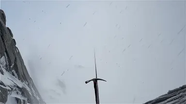 A fixed rope disappearing vertically into a whiteout blizzard on a high exposed couloir, slow tilt down from the white void a
